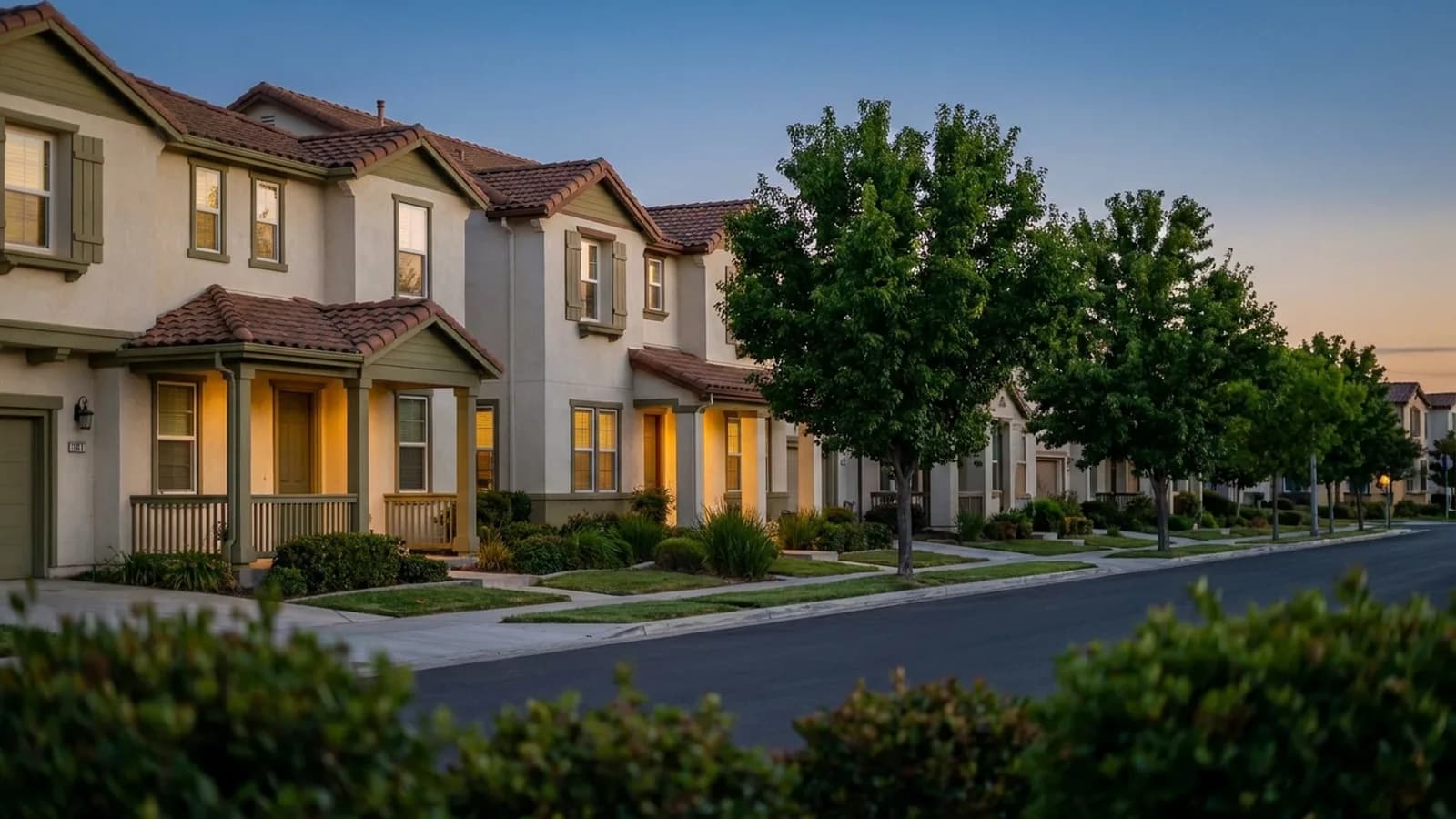 A uniform tract-home street where several near-identical houses repeat down the block